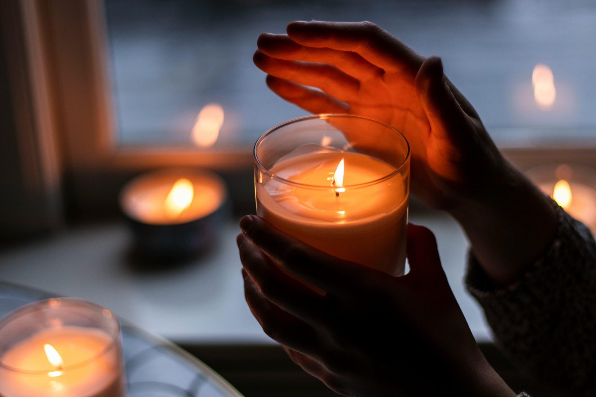 Hands holding a candle